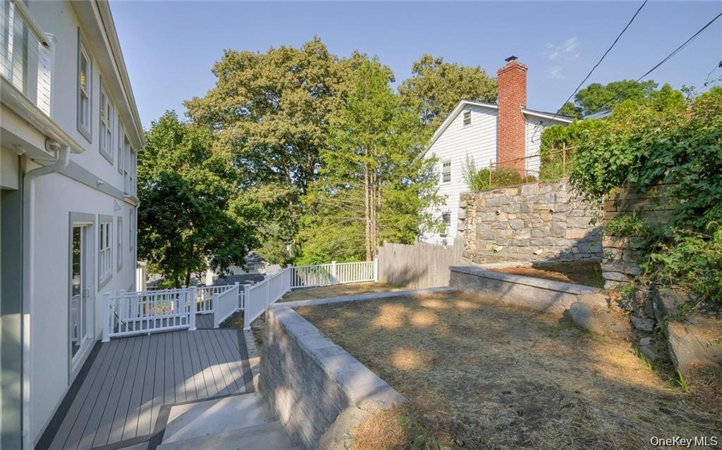 View of yard with a wooden deck