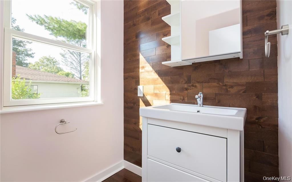 Bathroom featuring vanity and wooden walls