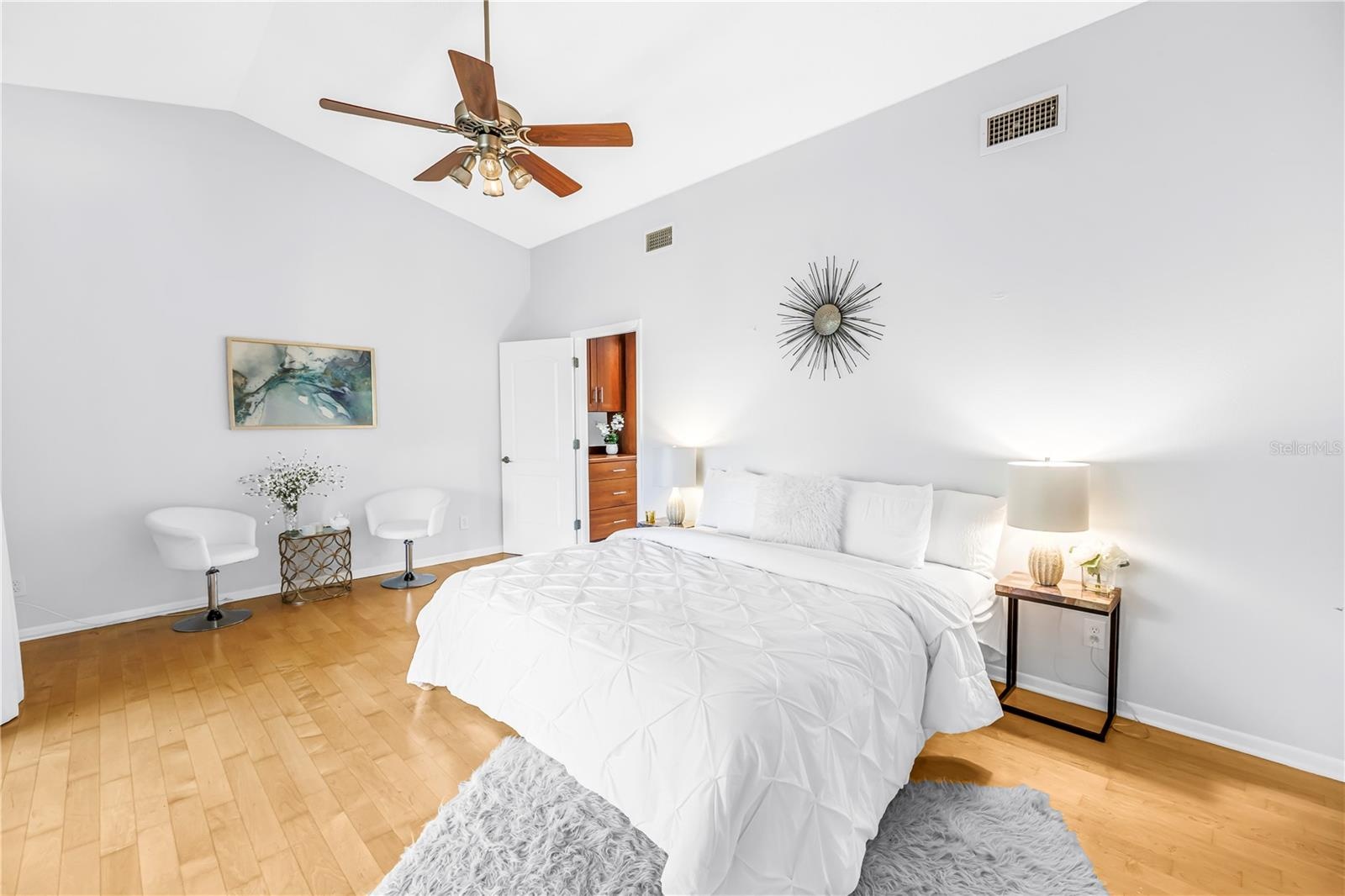 Upstairs Primary Bedroom Suite is Expansive with Vaulted Ceiling and Seating area.