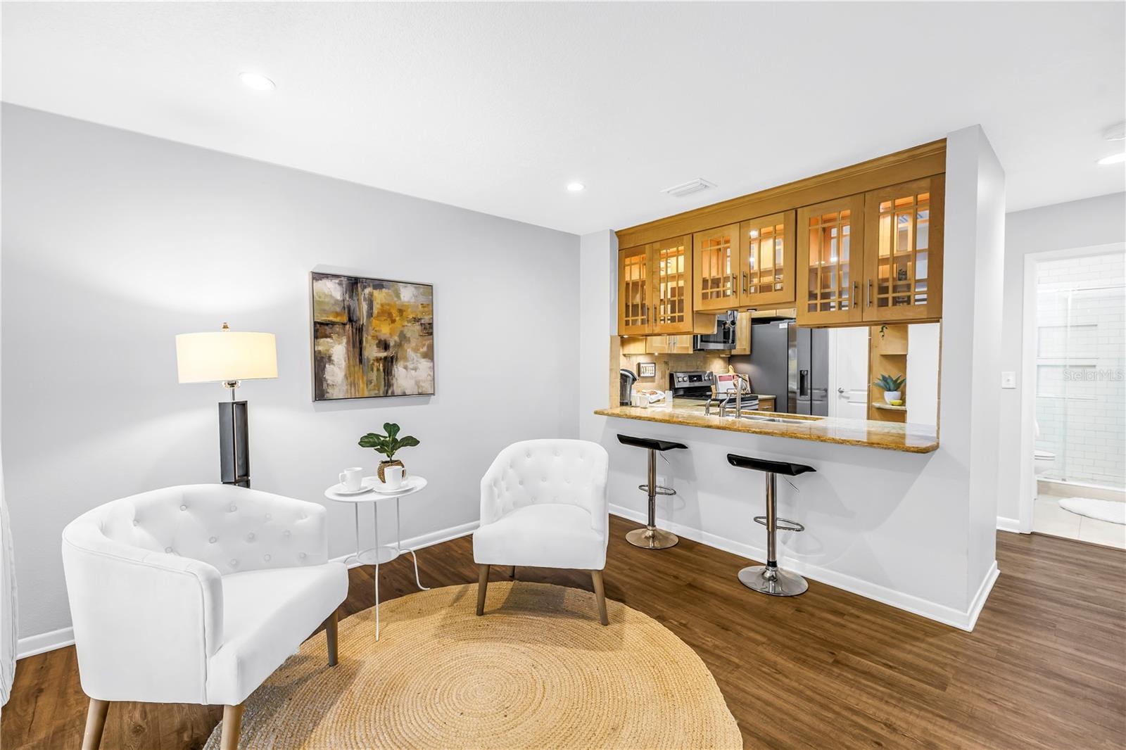 Sophisticated Kitchen and Lounge area opens to screened porch and expansive grassy fenced yard