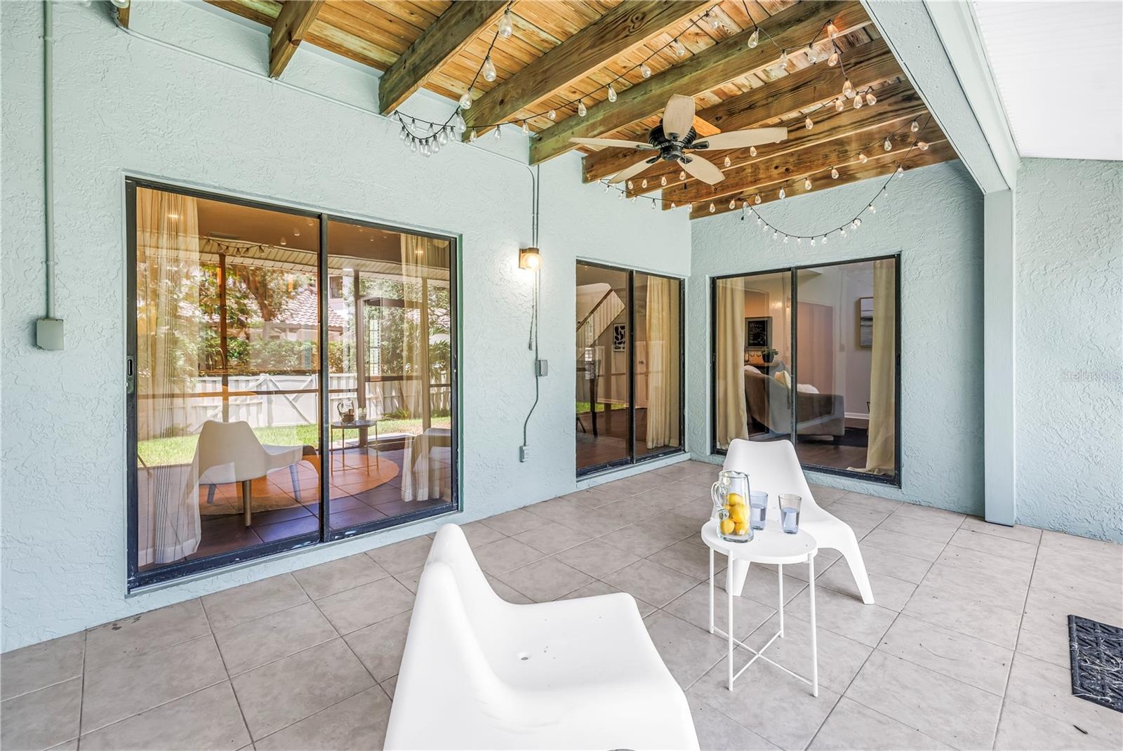 Downstairs Sliders Open Interior to Screened Covered back patio and Grassy Backyard maintained by the HOA
