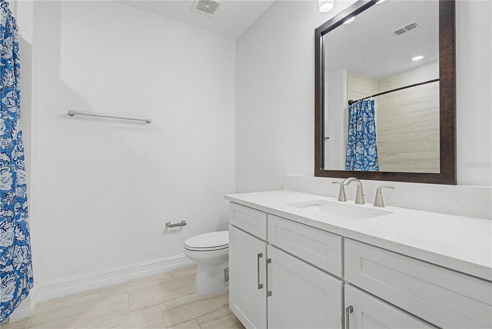 Third-level bathroom with a clean, modern design.