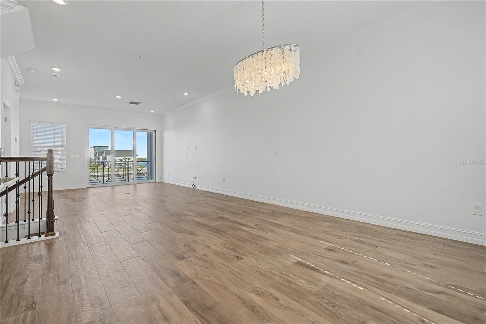 Second-level living area viewed from the kitchen, highlighting the open-concept layout.