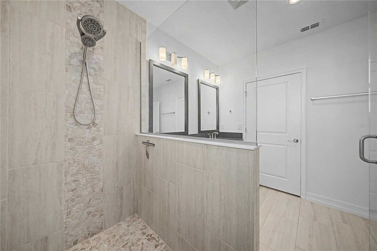 Third-level primary bathrooms beautifully designed, spacious walk-in shower