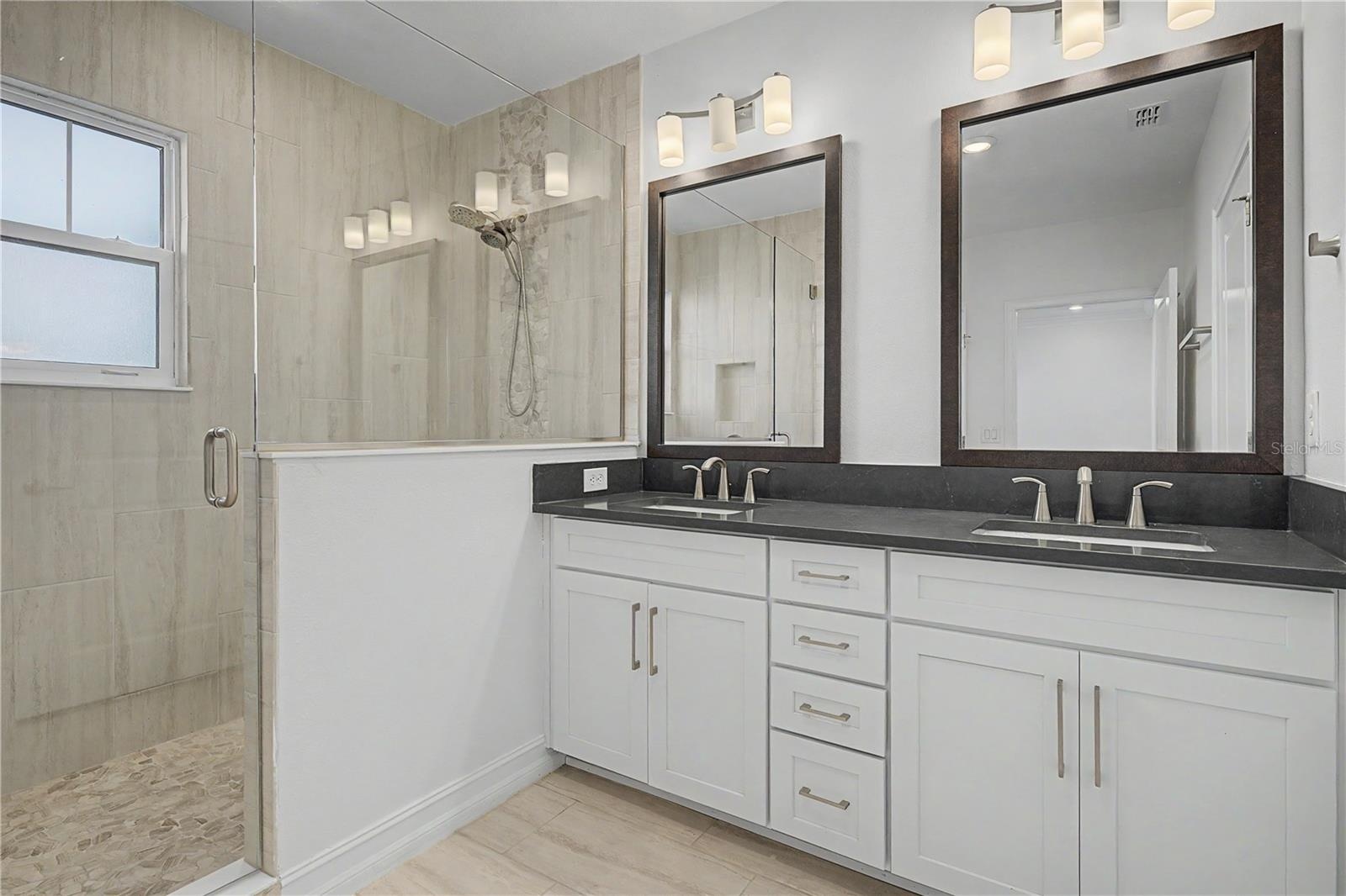Third-level primary en-suite featuring double sinks and a spacious walk-in shower.