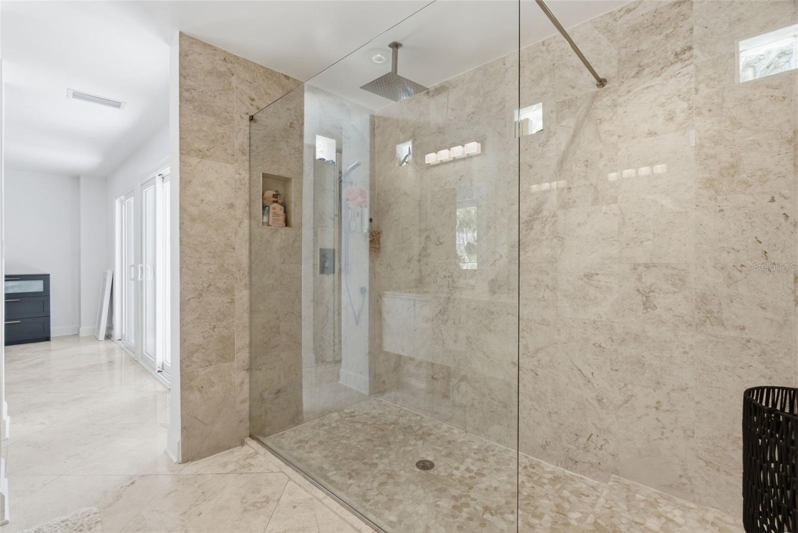 Step-in shower with multiple shower heads