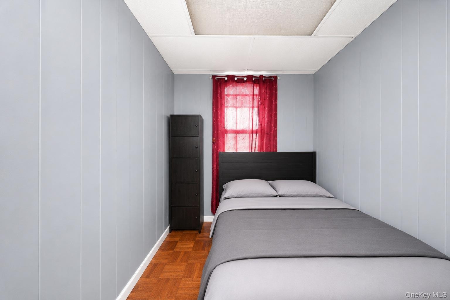 Wood-finish flooring with panel walls and a window