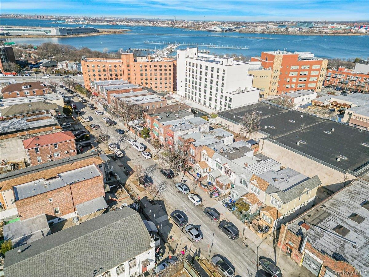 Birds eye view of property featuring a view of city and a water view