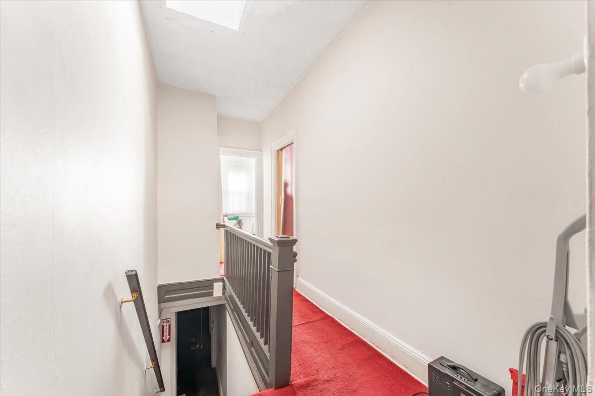 Stairs with carpet floors, a skylight, and baseboards