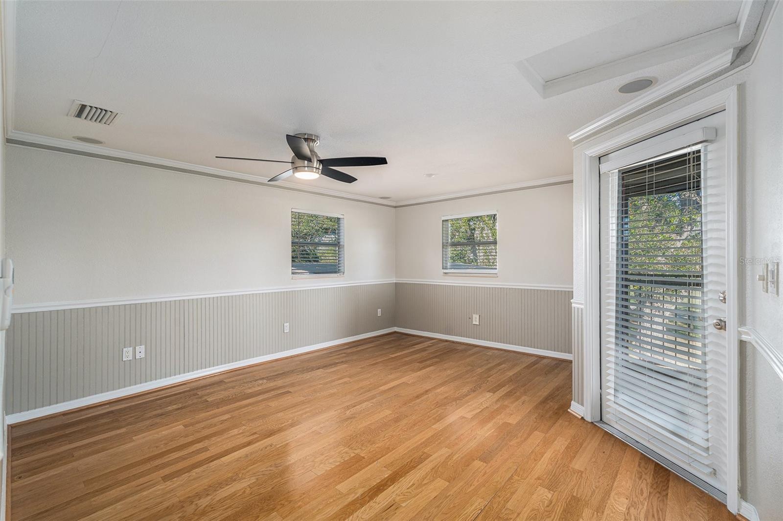 Primary bedroom with screened balcony