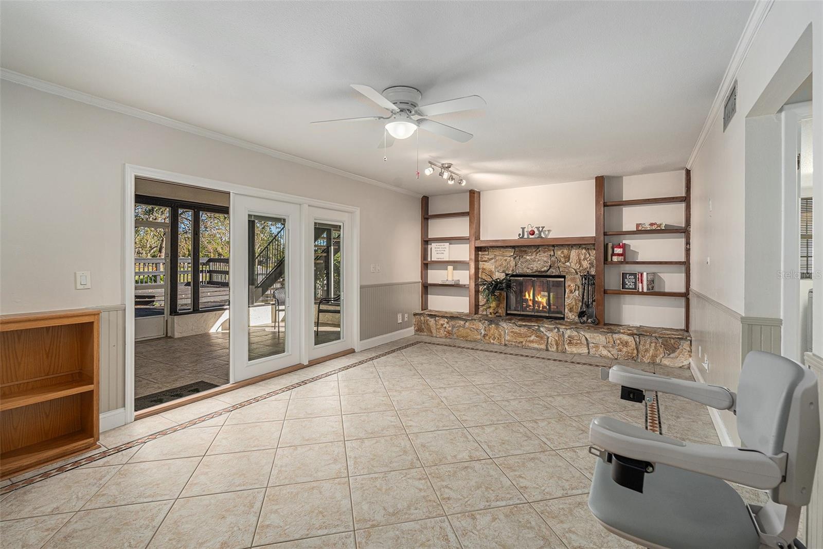 Family room with french doors out to lanai and pool