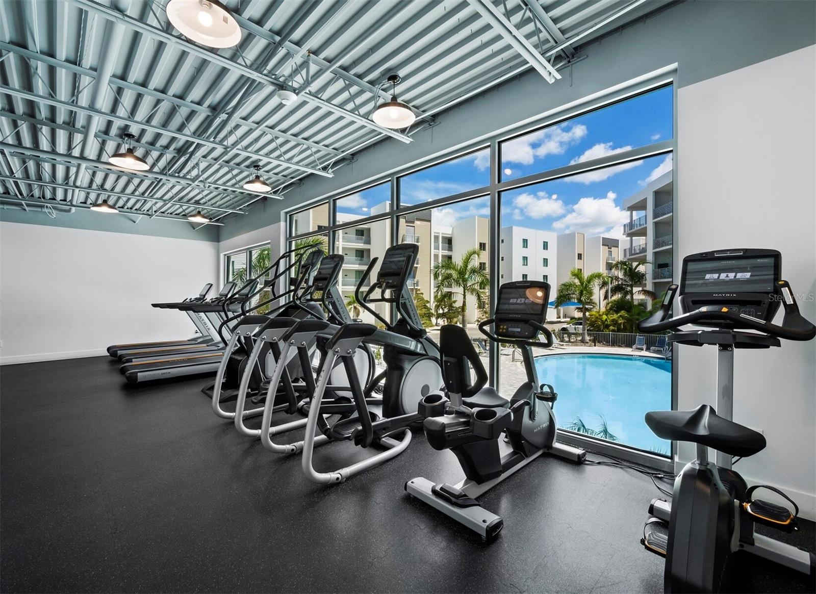 Well equipped fitness center overlooking pool