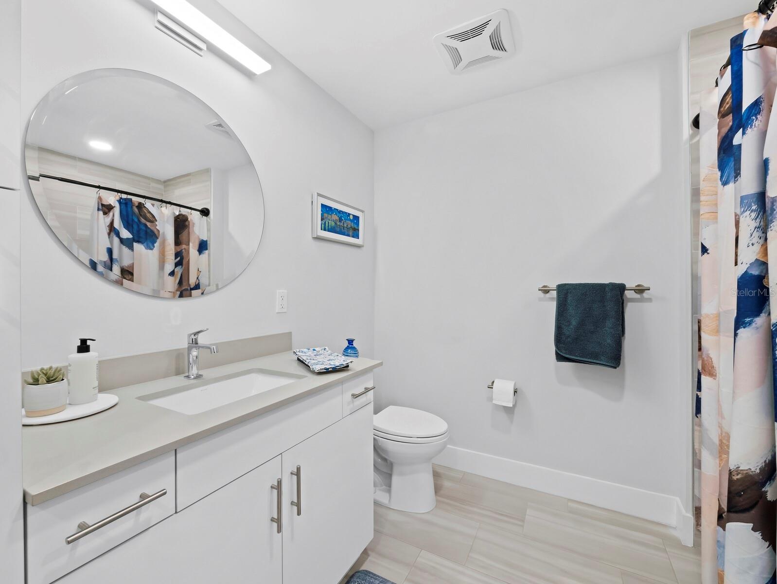 2nd full guest bath with tile floors & upgraded lighting