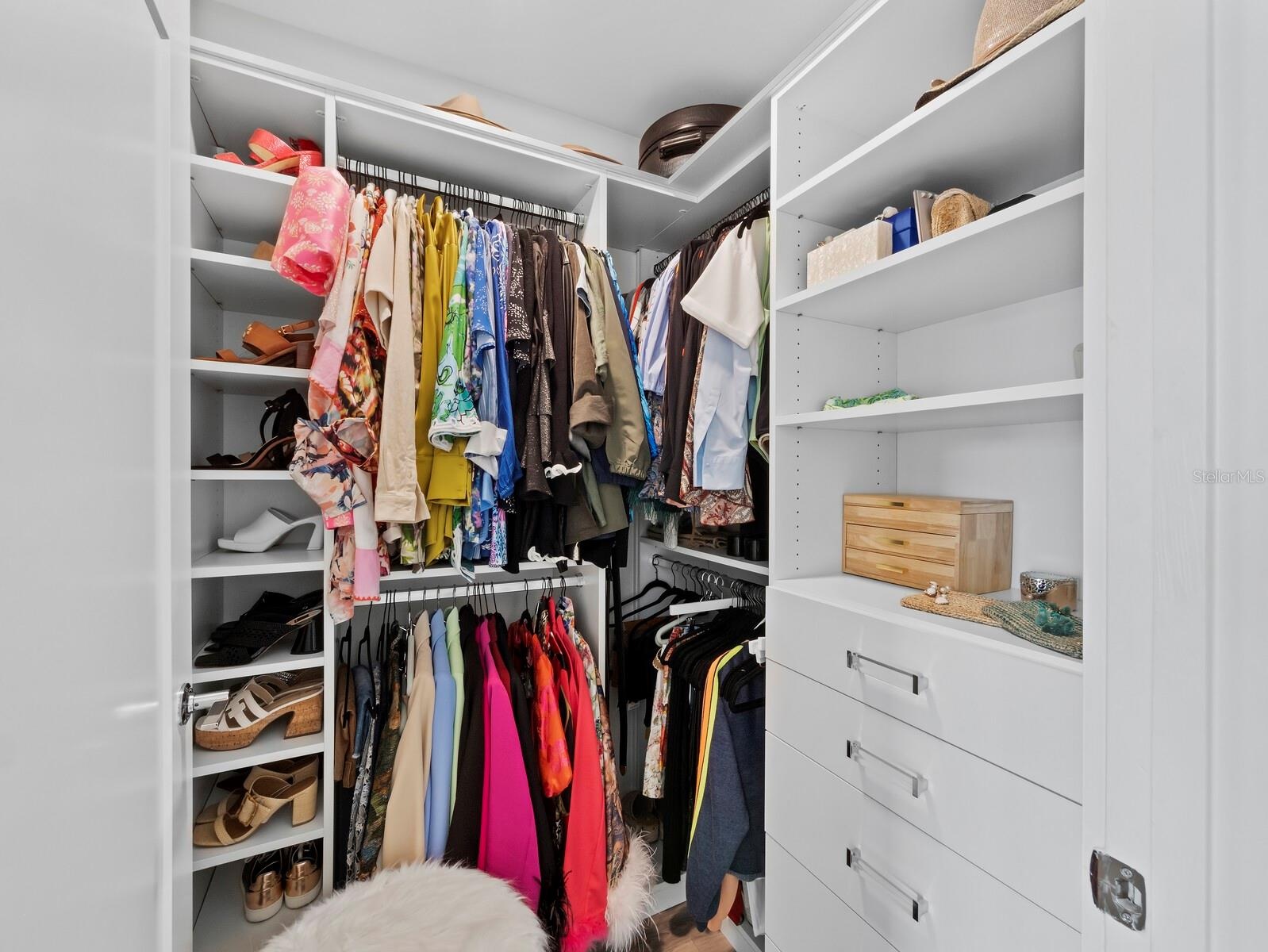 California closet system in main bedroom walk in closet