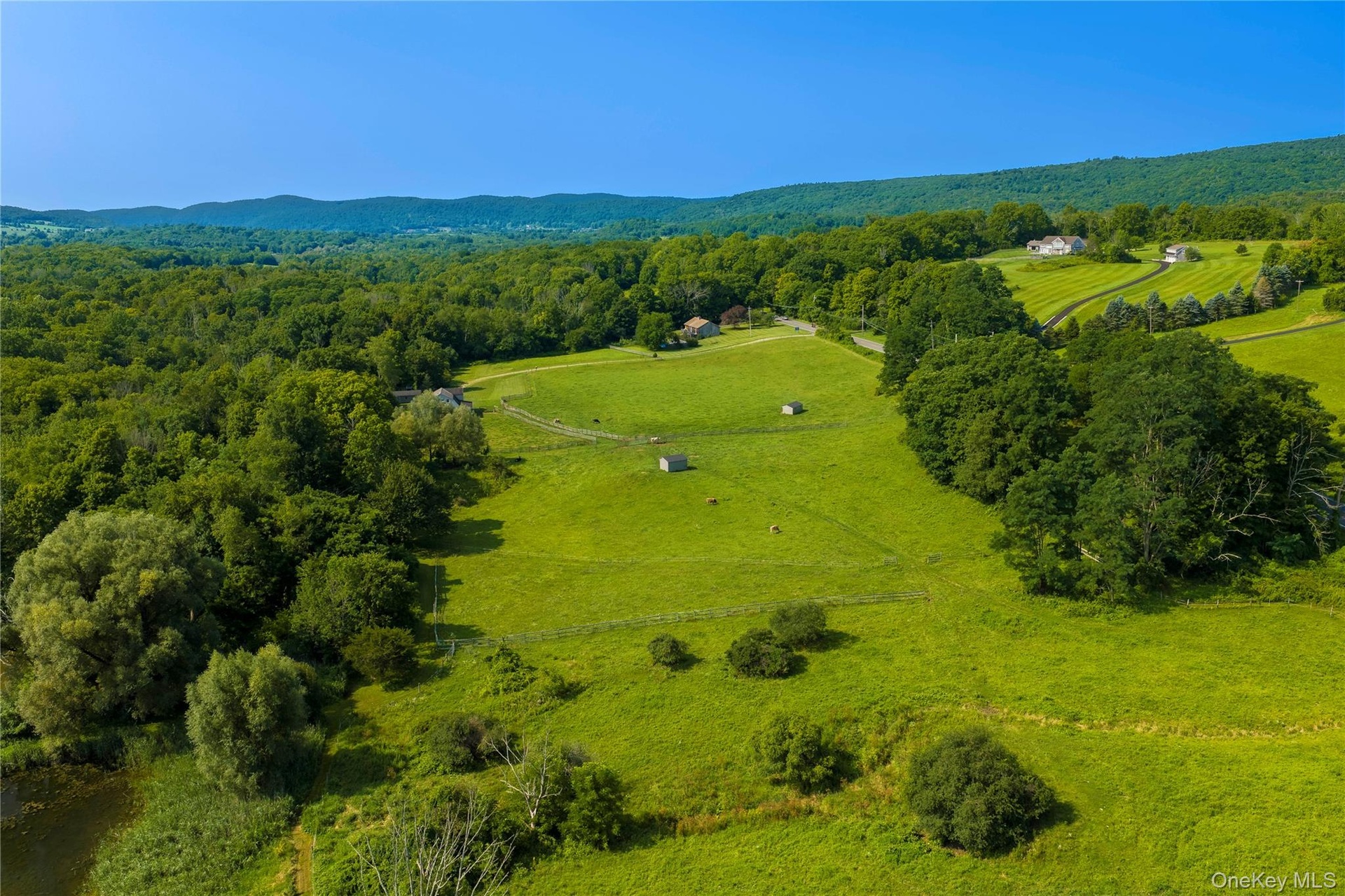 Pastures, several run-ins, and a pond in the lower left corner.