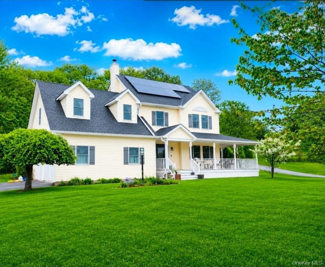 Inviting Colonial with wrap-around front Porch at the end of a cul-de-sac on over an acre