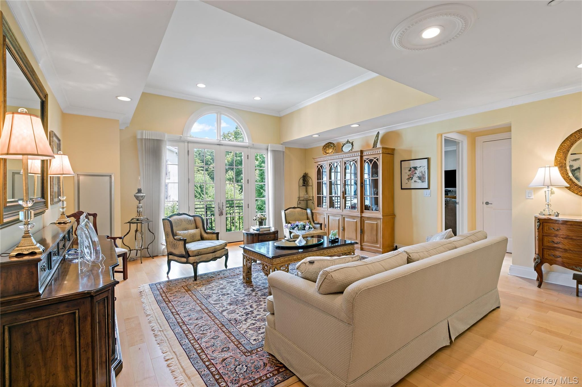 Soaring ceilings and oversized windows create a dramatic, light-filled living space.