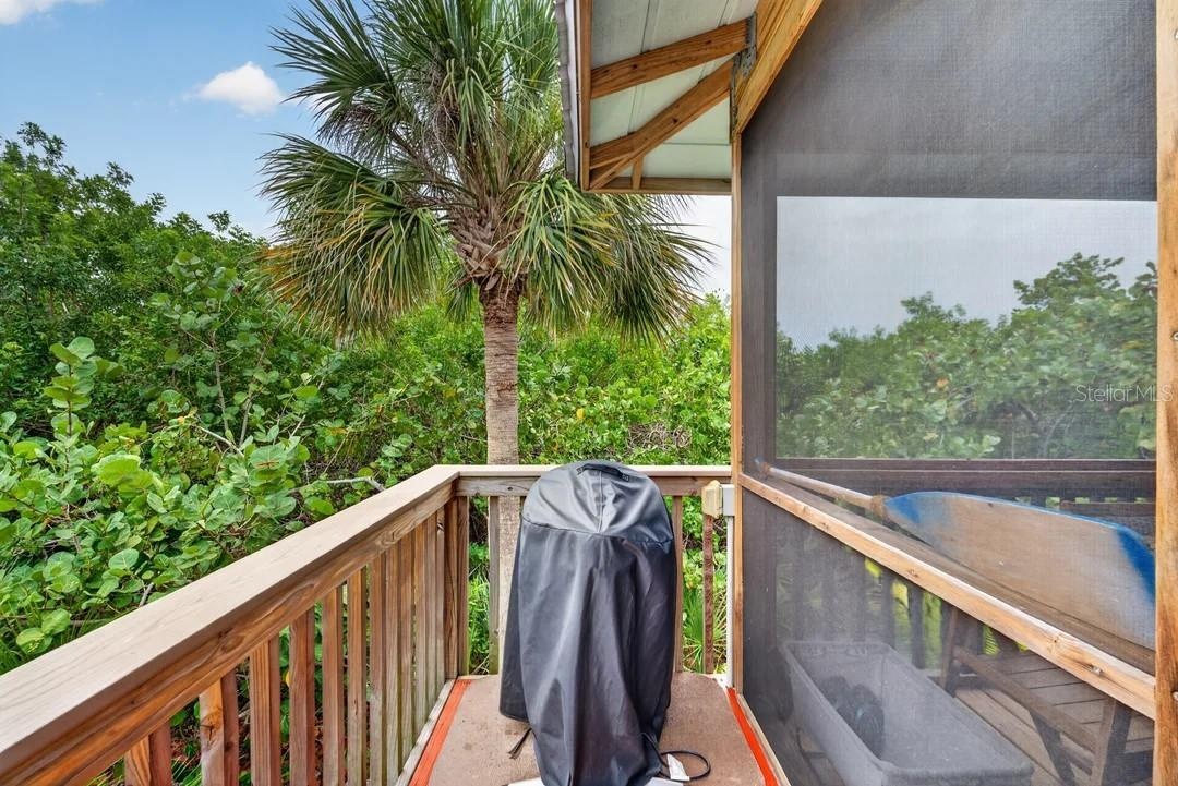 side deck off the porch where grill is located