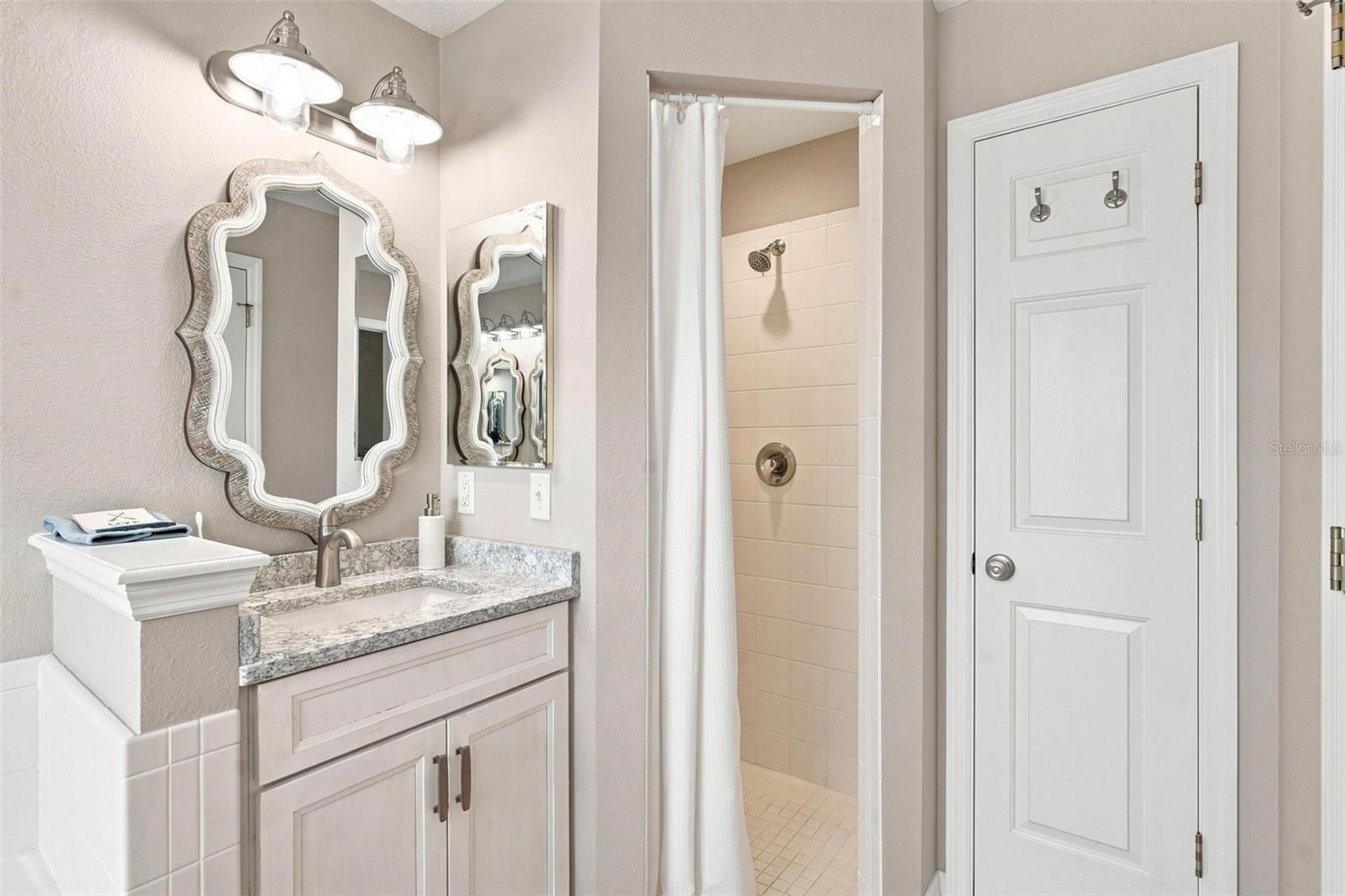 Primary bathroom shower and linen closet