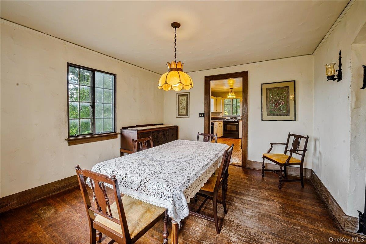 Dining room off living room with hardwood floors leading into Kitchen