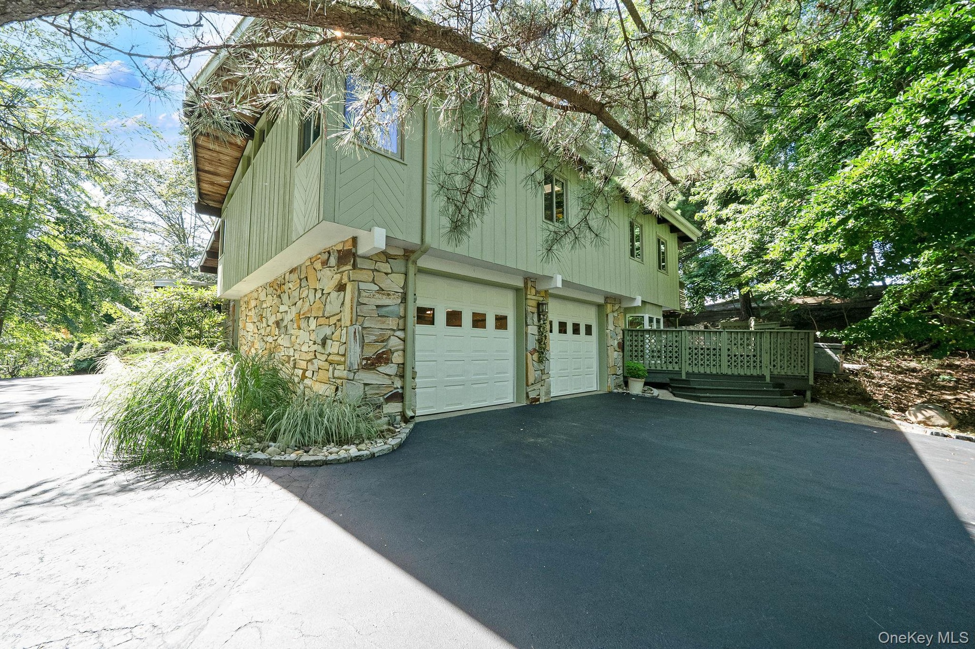 Stone and siding exterior with a two-car garage
