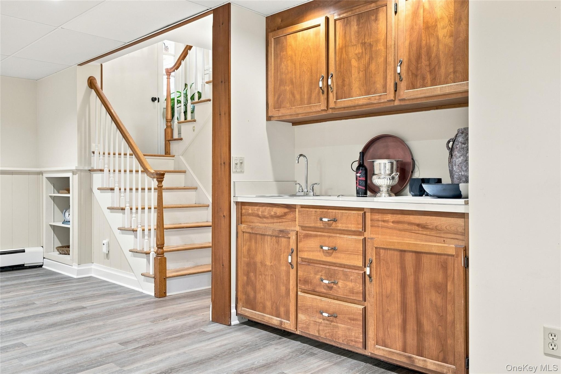 Stairs to lower finished living space.  Wet Bar , full bath and more.