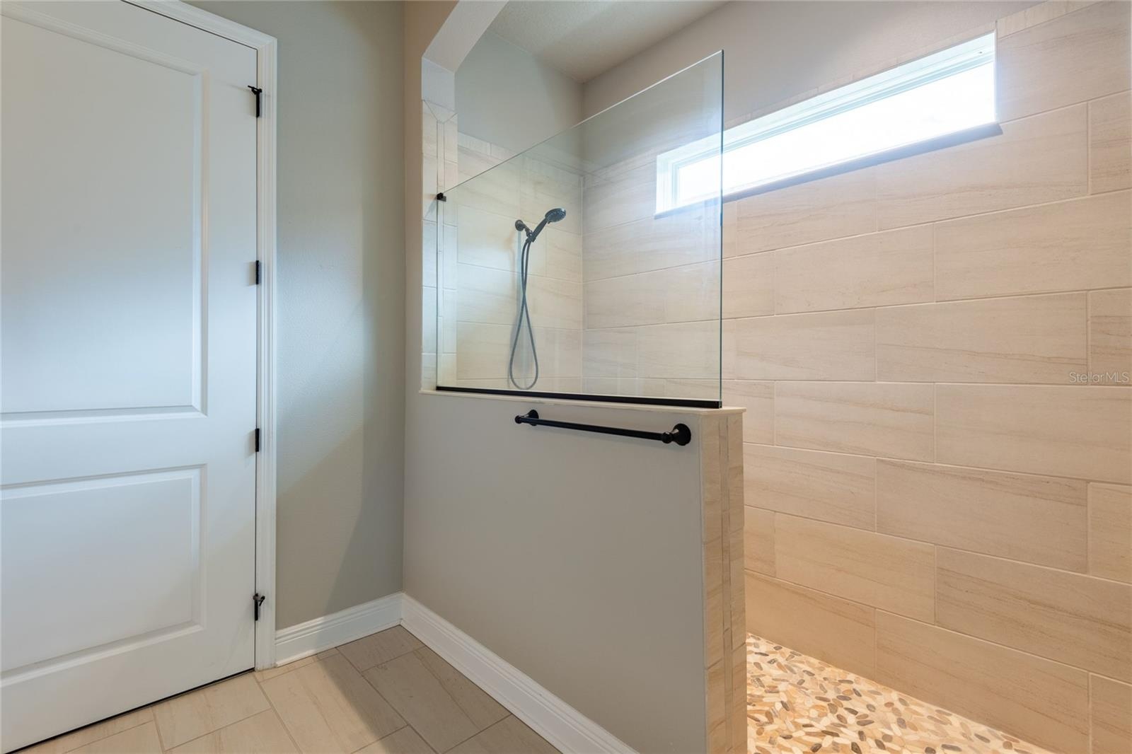 Large walk-in shower. The door leads into the walk-in closet.