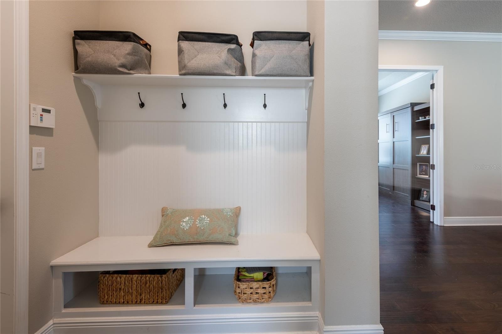 The drop area is located off of the kitchen and leads to the laundry room and the garage.