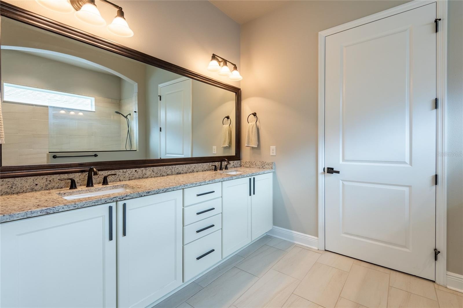 Dual sinks with soft close drawers and cabinets.