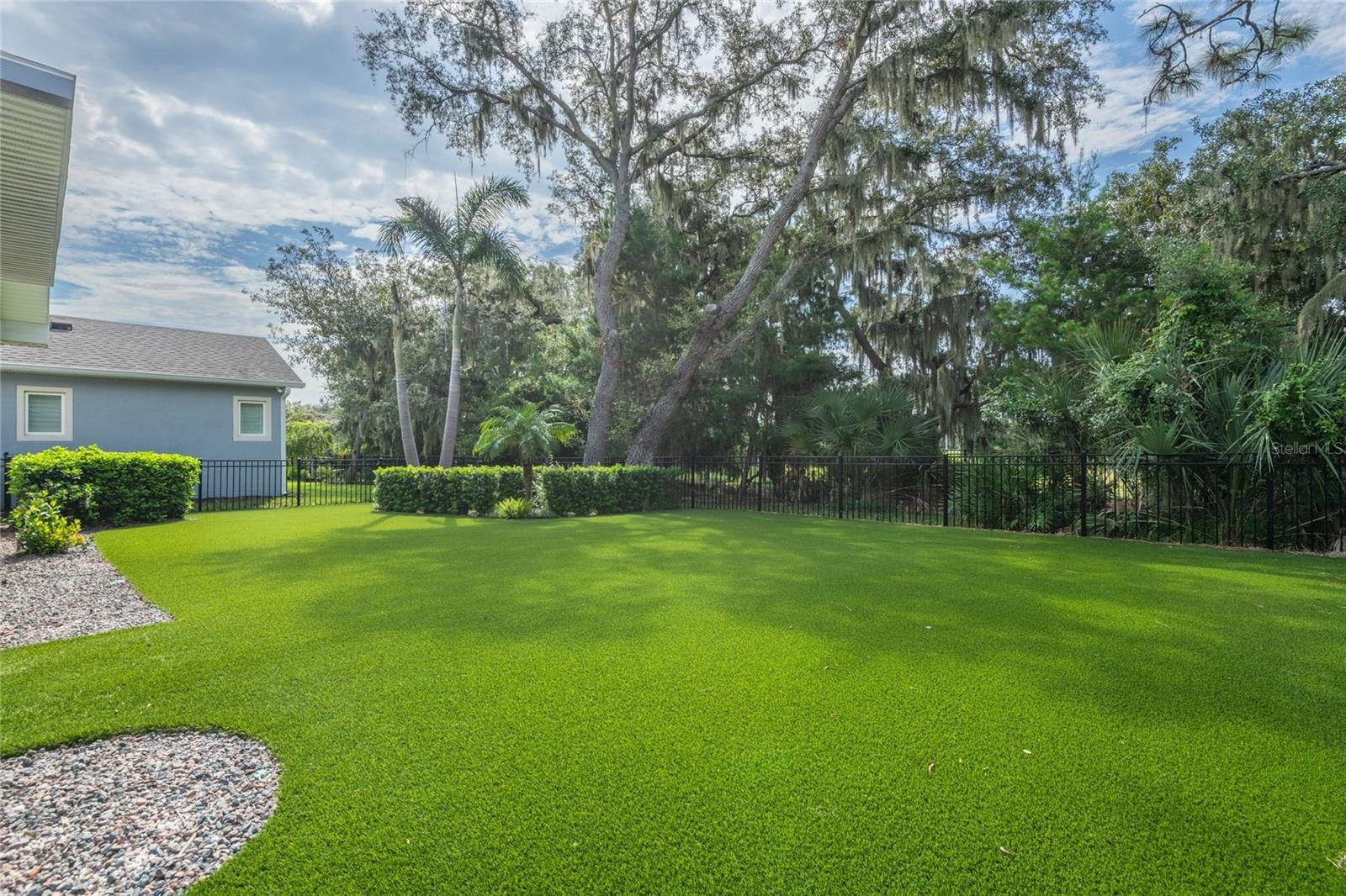 Fully fenced backyard with the low maintenance artifical turf.