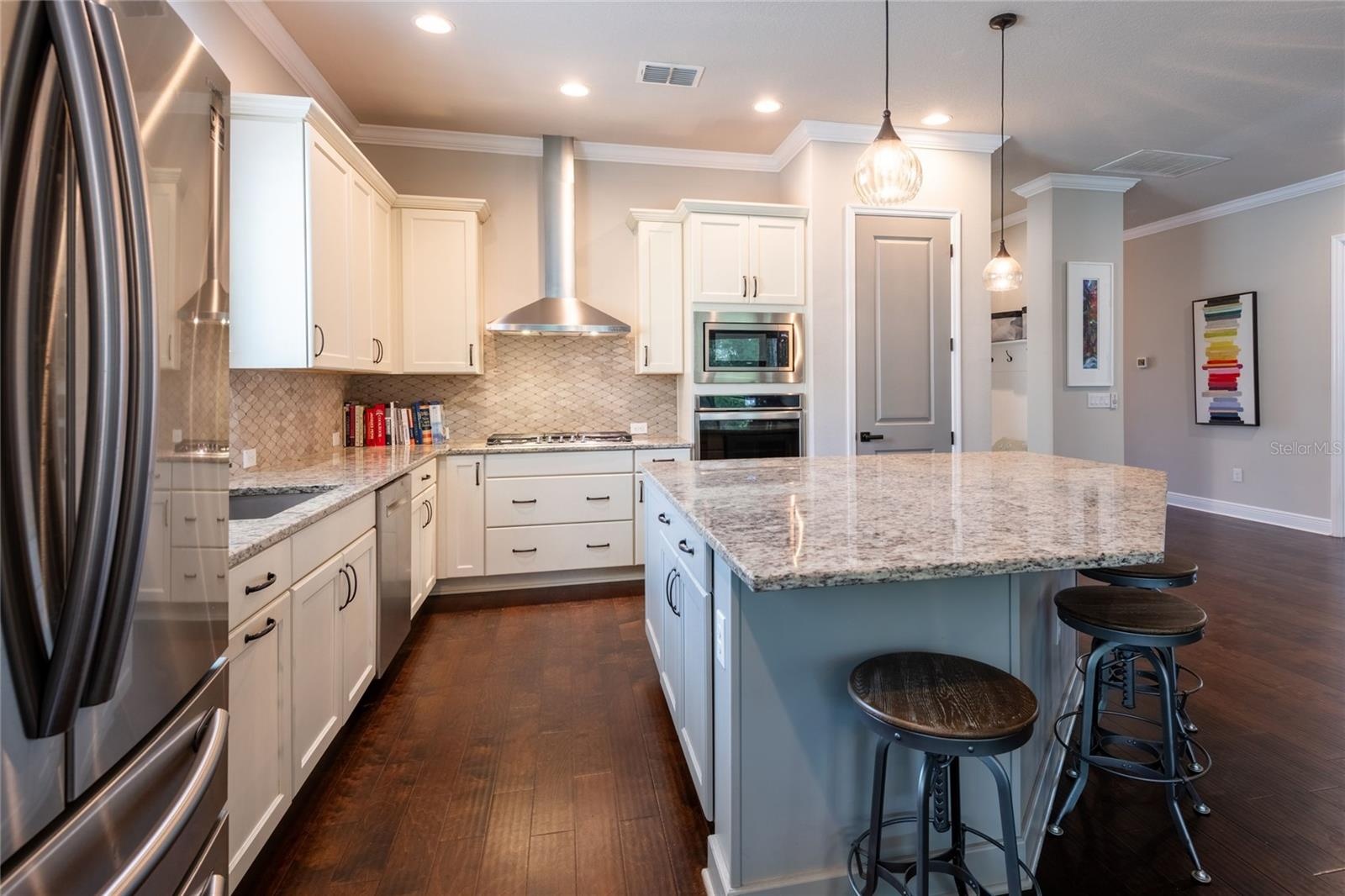 Gas range with soft close cabinets and drawers throughout the kitchen.