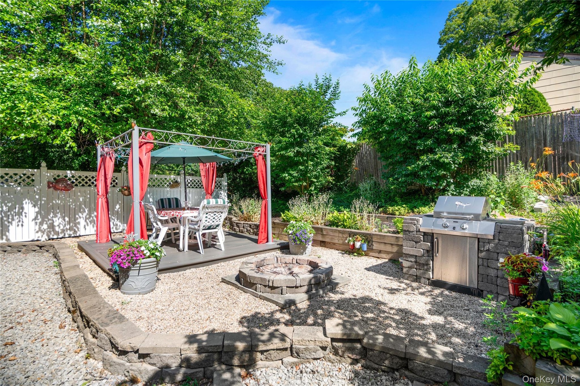 12' x 12' platform structure featuring a stone built-in BBQ and a custom fire pit.