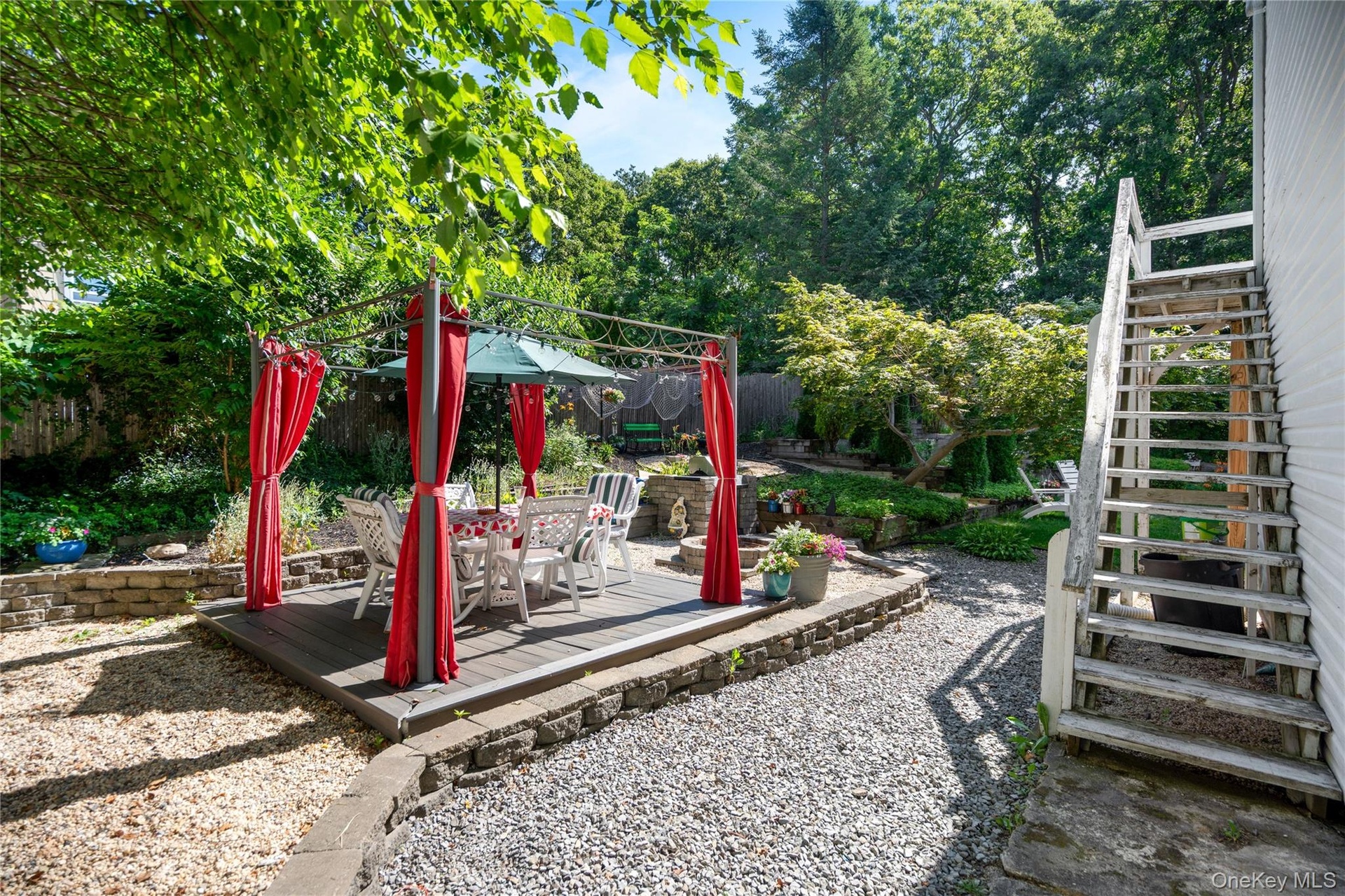 12' x 12' platform structure featuring a stone built-in BBQ and a custom fire pit.