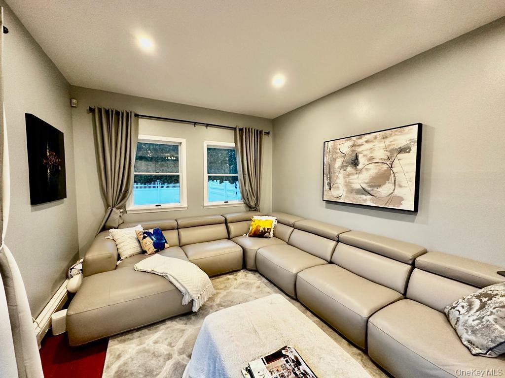 Family room with flat screen TV, opens to outdoor deck