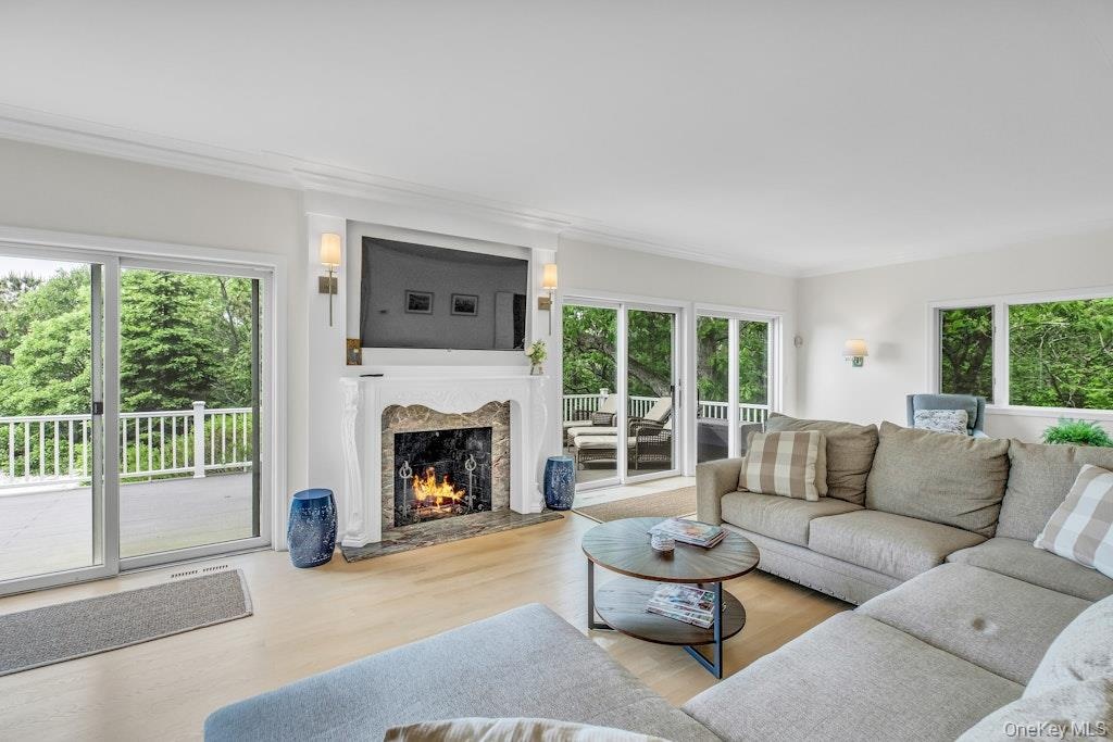 Living room with access to deck and water views