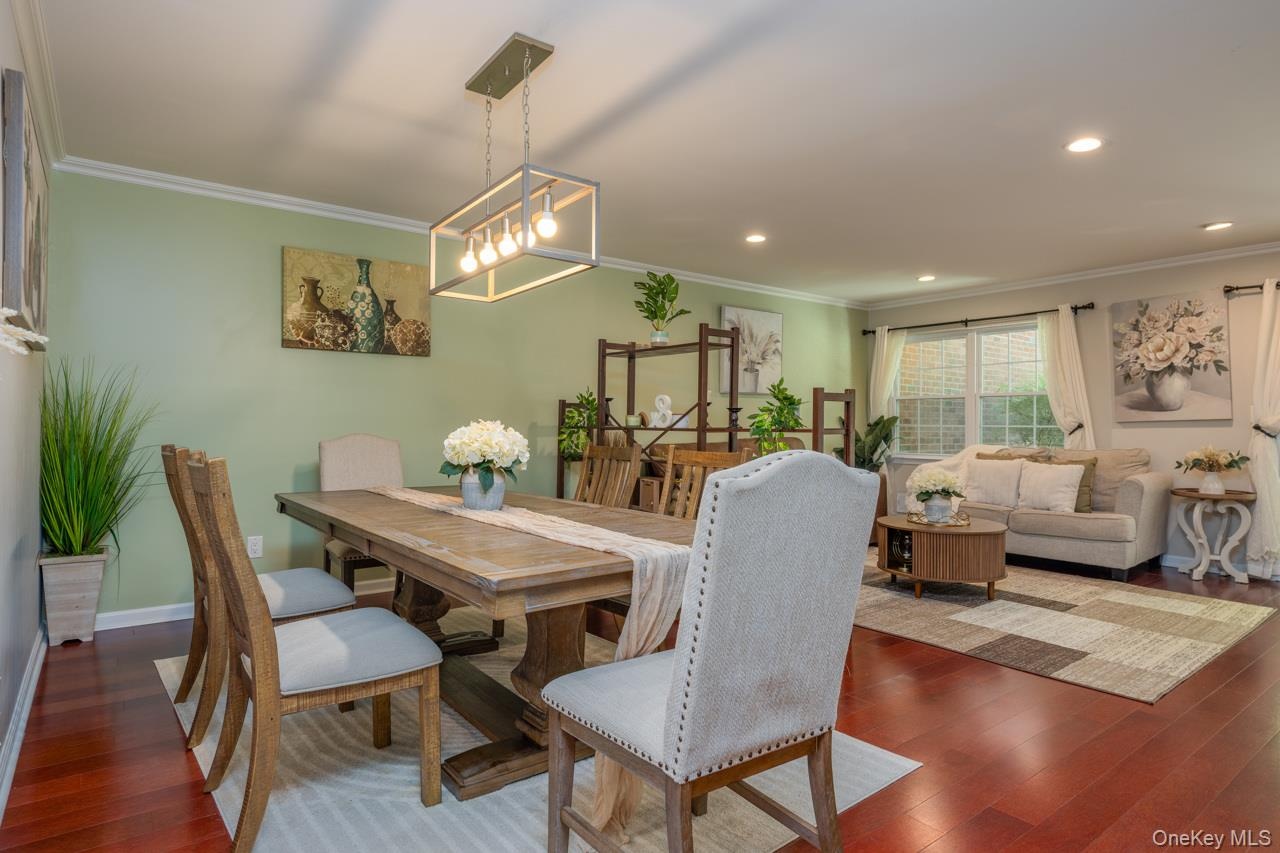 Beautiful adn luxurious flooring with recessed lighting and crown molding make for an extremely warm and inviting space.