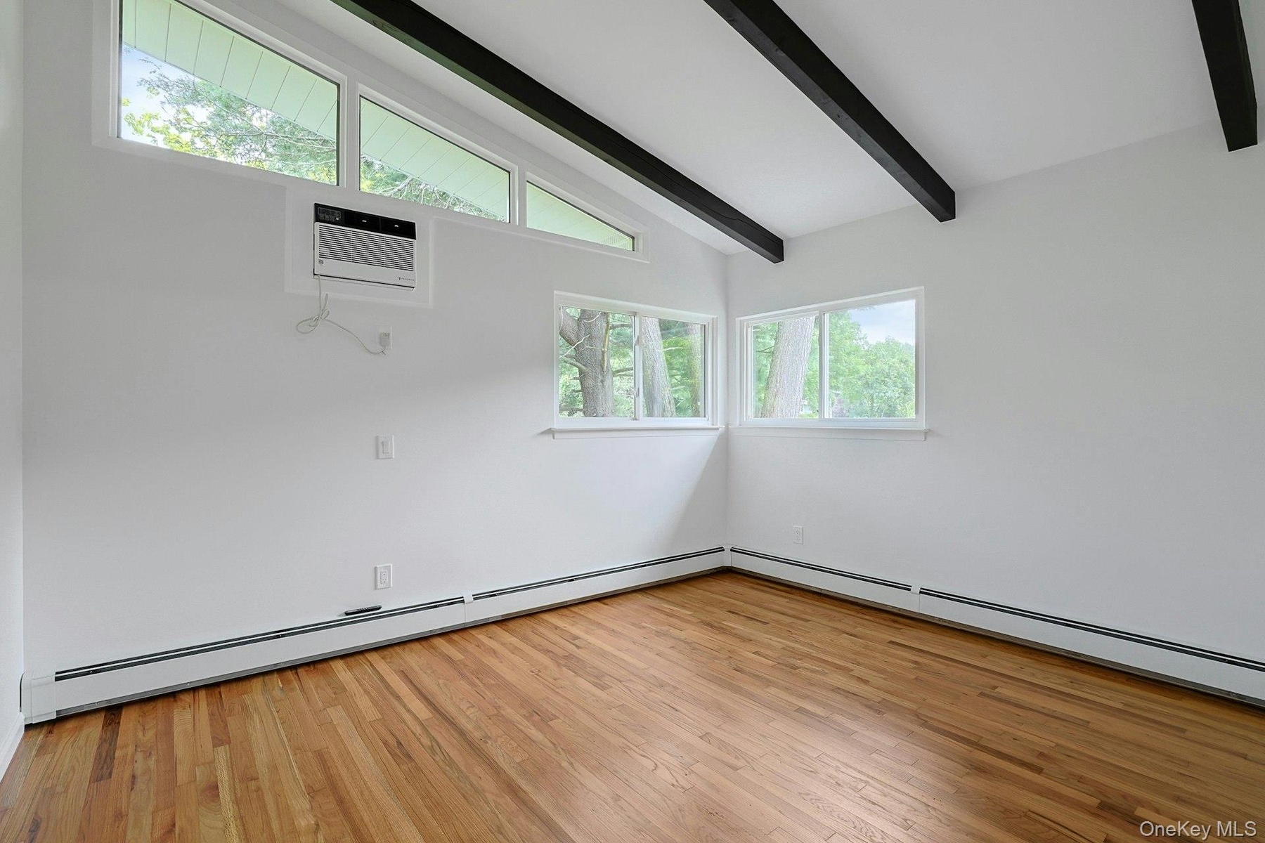 Bedroom # 2 with hardwood floor and beamed ceiling
