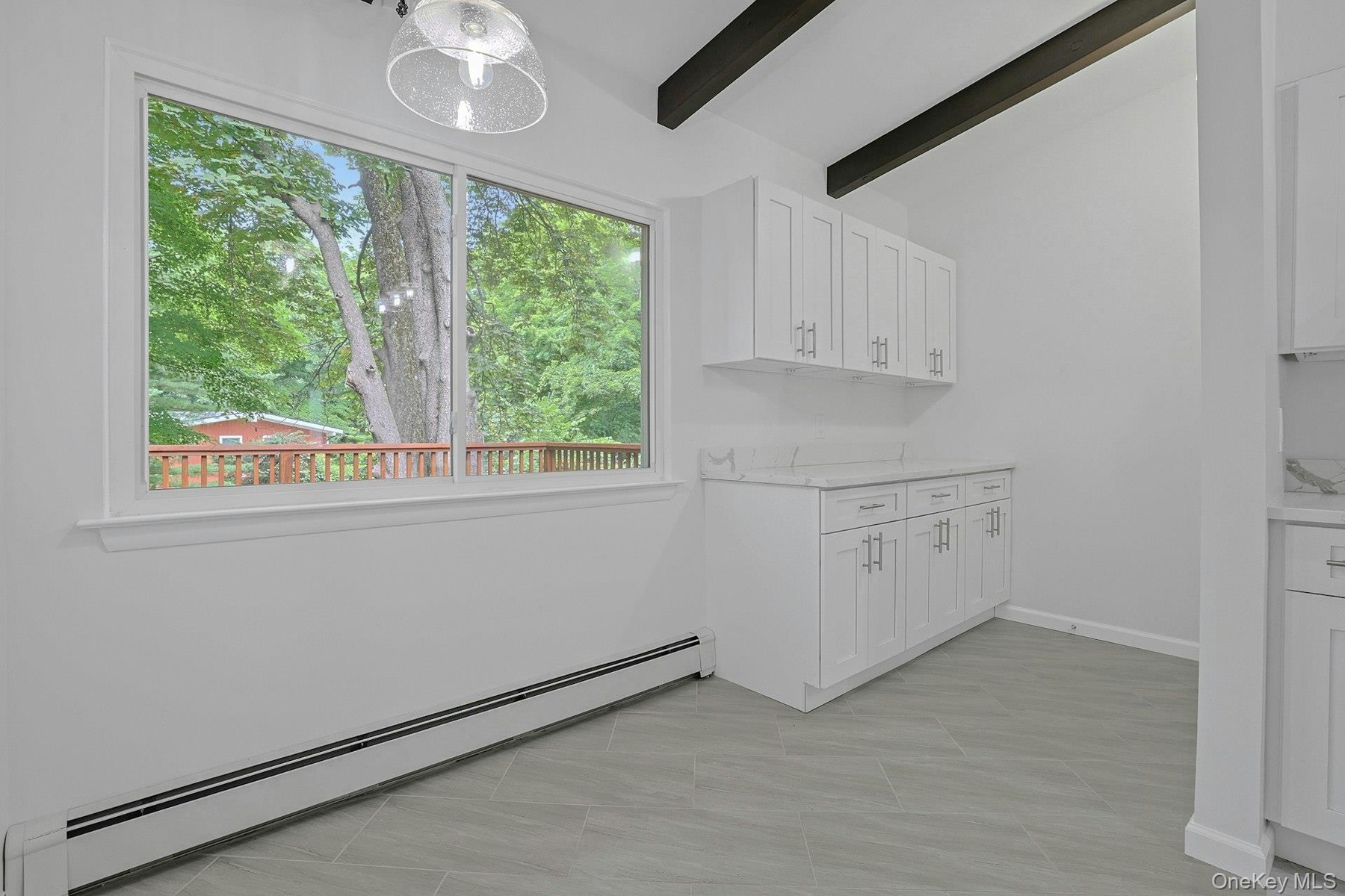 Large Kitchen window to look outside at the backyard also brining in lots of natural light
