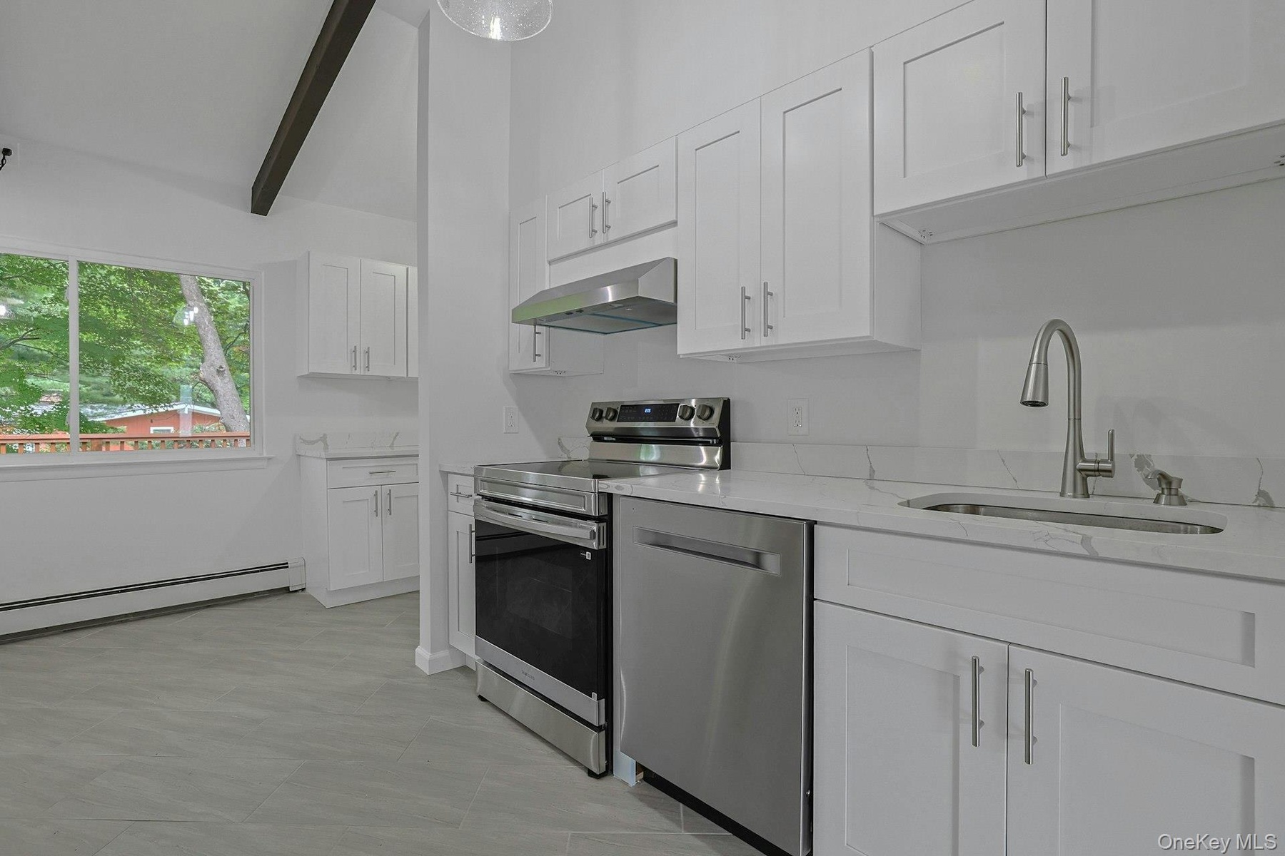 White cabinets, quartz countertops and all new stainless steel appliances