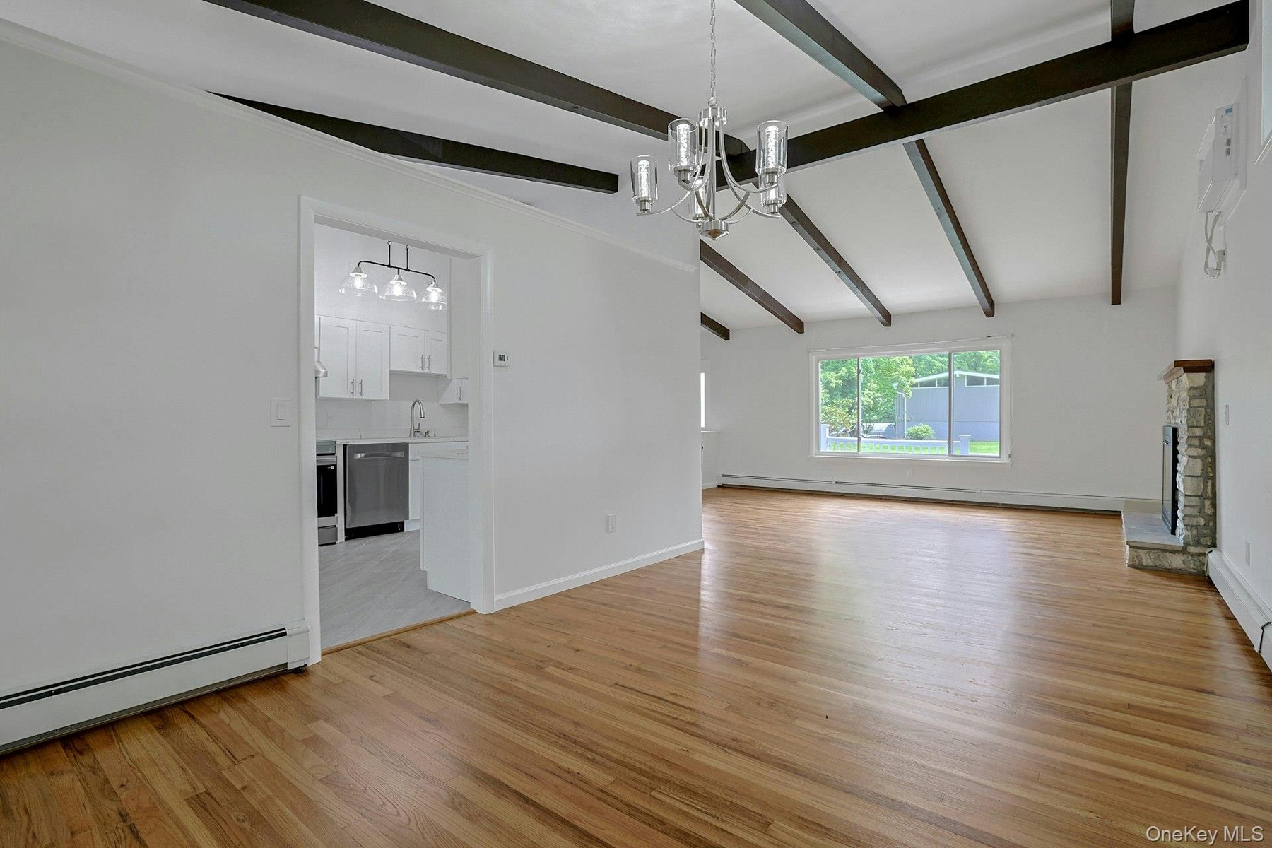 Another view of the dining room looking into the kitchen and living room showcasing the open floor plan