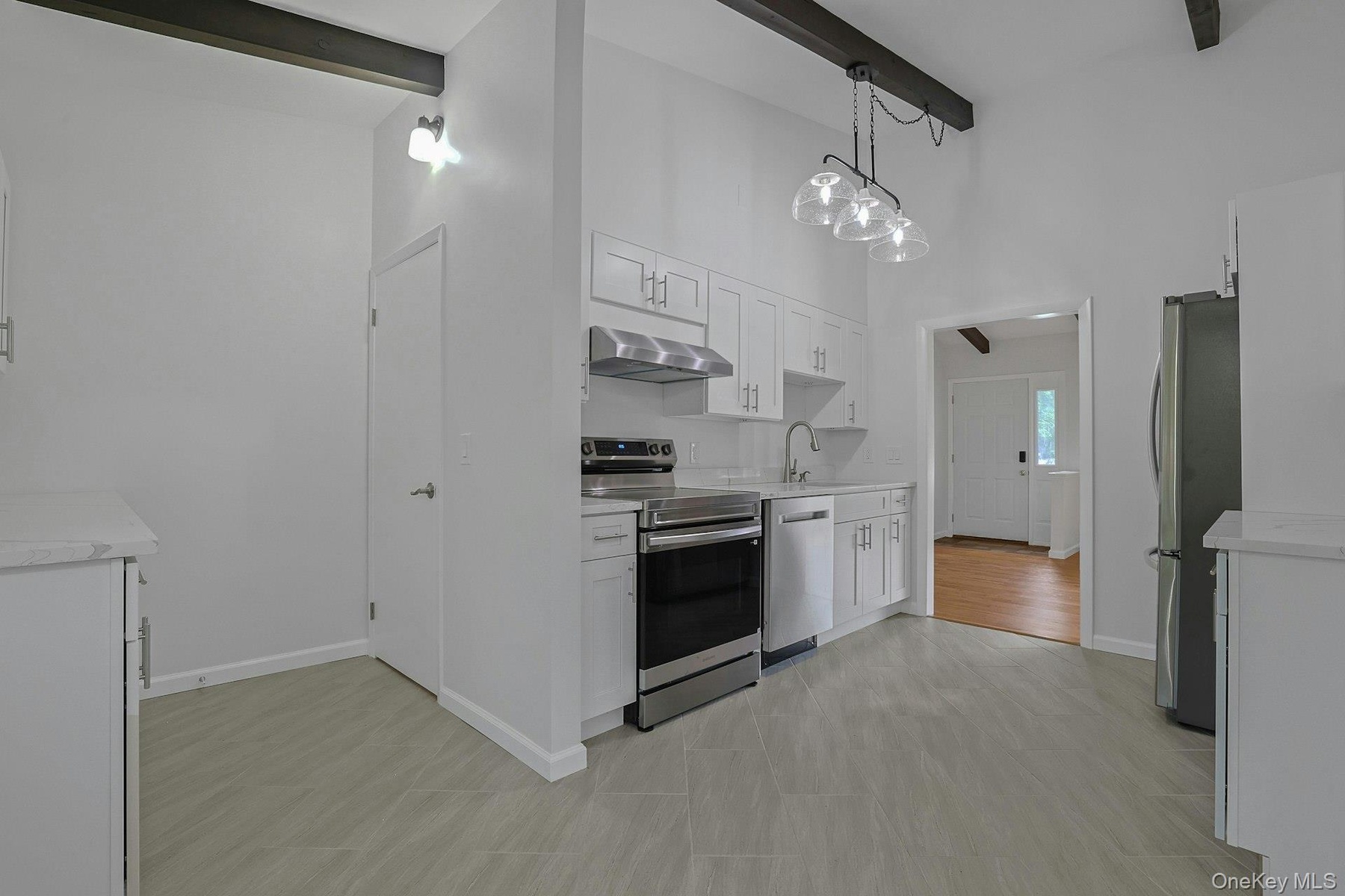Eat in Kitchen with tile floors and beamed ceiling