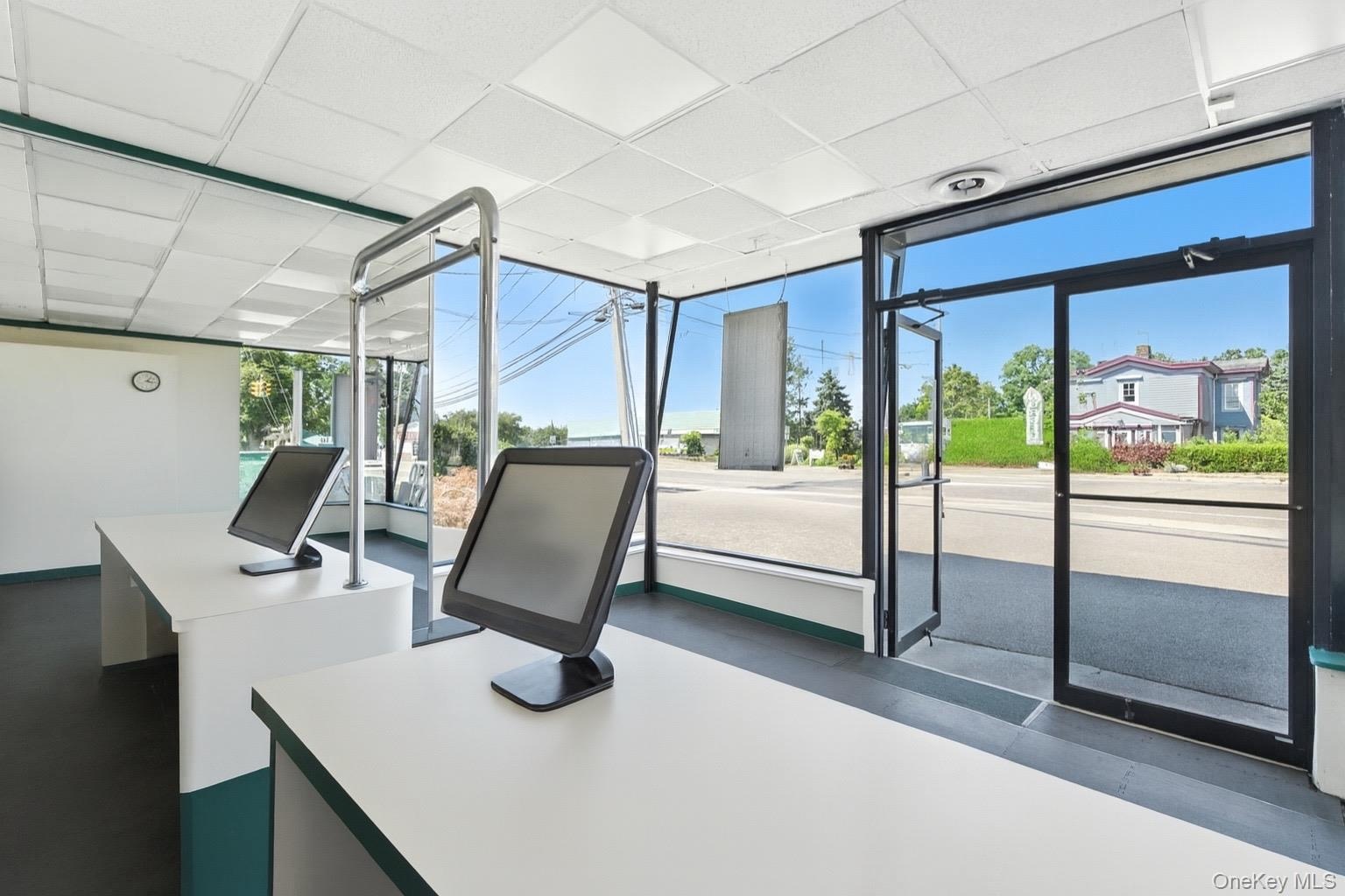 Office space featuring a drop ceiling and expansive windows