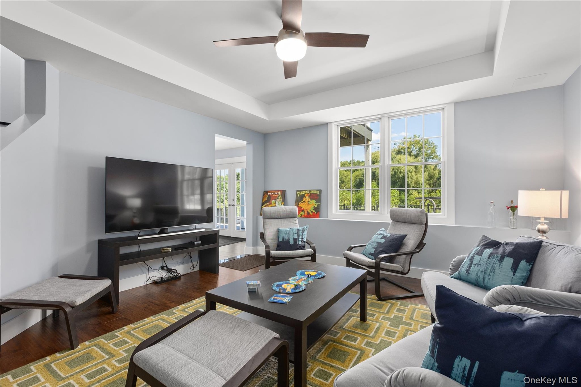 Proceeding to the lower level, you’ll discover the same refined style and thoughtful architectural details found throughout the home, where a lovely f