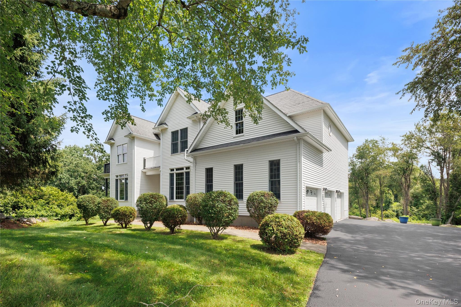 This elegant Colonial showcases timeless architecture, manicured grounds, an expansive driveway, and exceptional curb appeal, creating a welcoming set