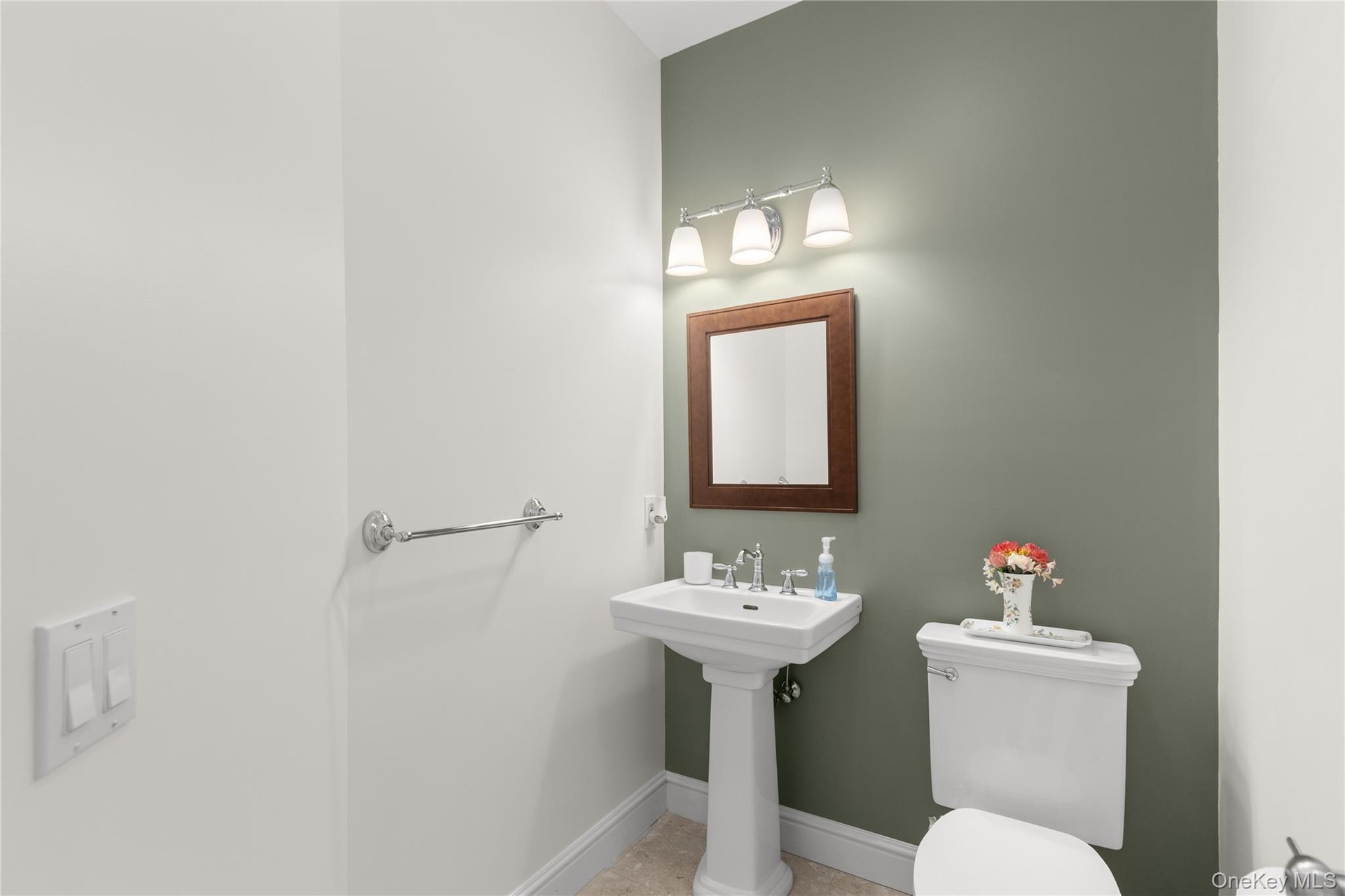 Conveniently located on the main level, the powder room adds comfort and convenience for guests, thoughtfully completing the home's well-designed livi
