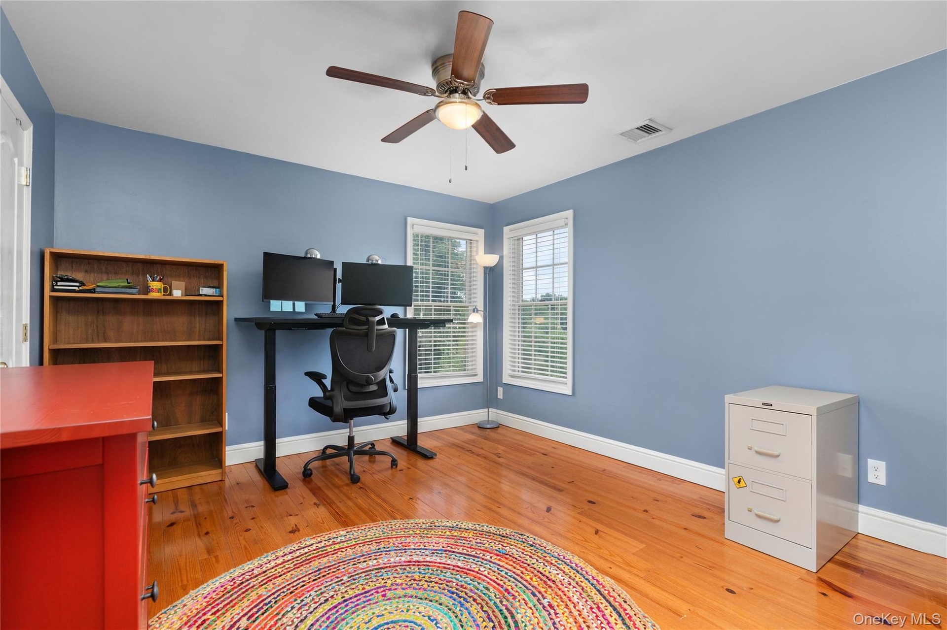The second upstairs bedroom, currently utilized as a home office, shares the thoughtfully designed adjoining bath and offers versatile living space th