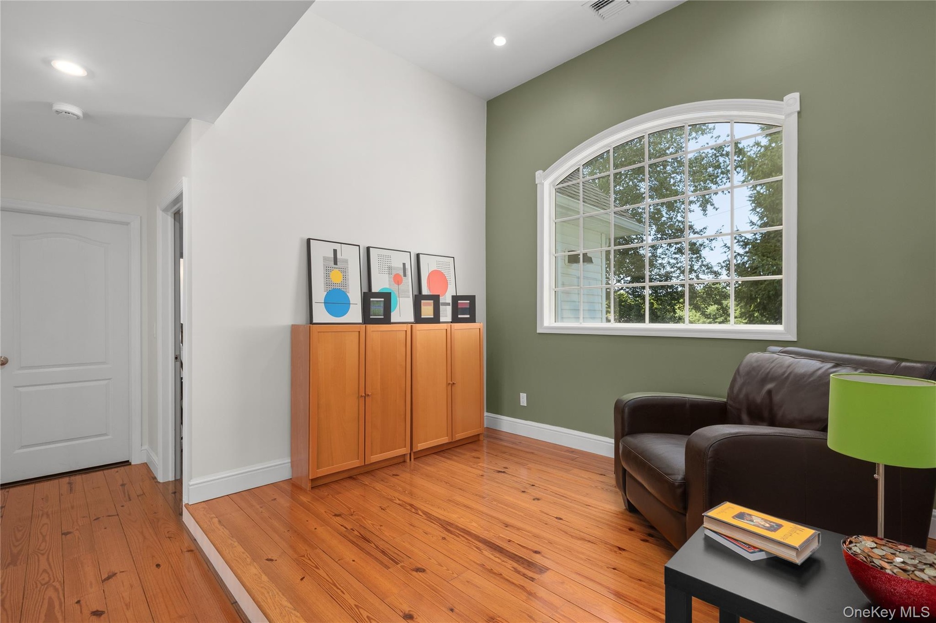 Thoughtfully situated between the second-level bedrooms, this light infused inviting open space features pinewood floors and a vaulted ceiling, creati