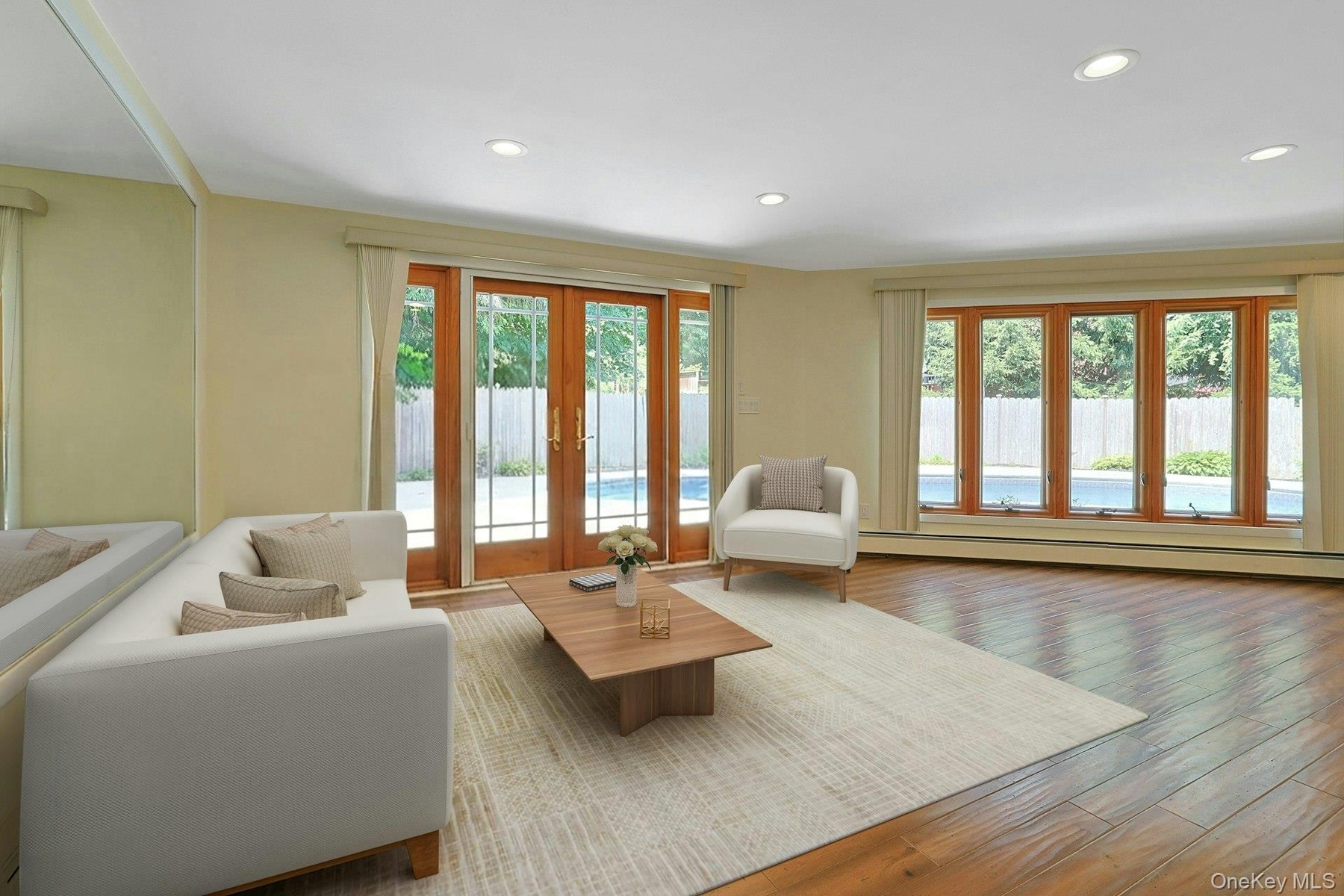 Off of the primary bedroom is this flexible space. A wonderful family room now, doors here also open to the pool. The lass doors and wall of windows e
