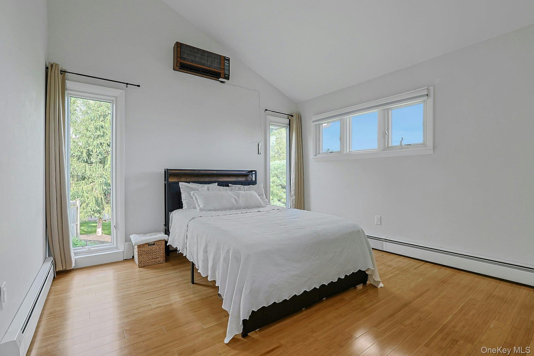 The largest of the other three bedrooms, this corner room with nearly floor to ceiling windows has a deep closet. Vaulted ceilings in this space soar 