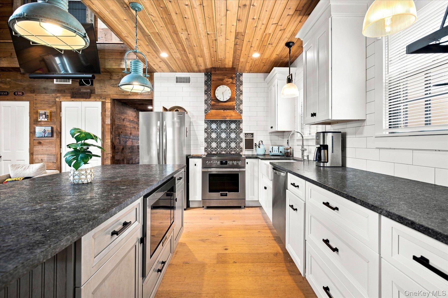 Brand new kitchen with stainless steel appliances, and subway tile backsplash